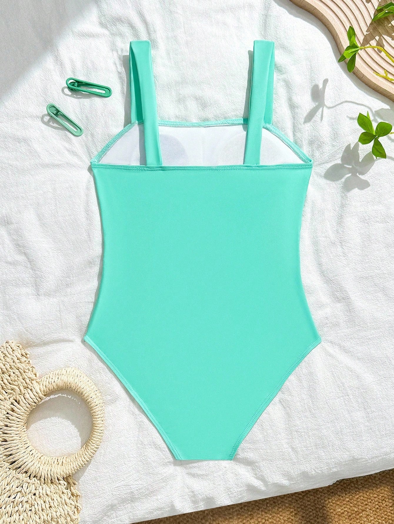 Tween girl multicolor ombre one-piece swimsuit with spaghetti straps, all-over print, lined body, and vacation beachwear style.