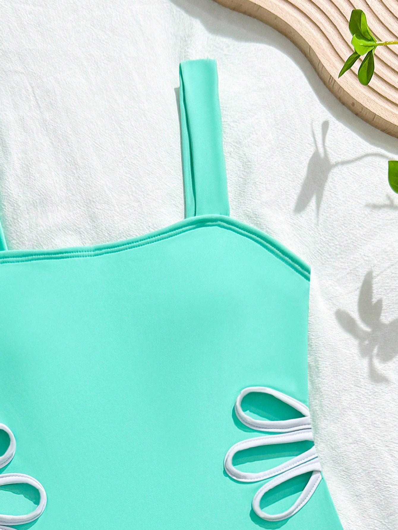 Tween girl multicolor ombre one-piece swimsuit with spaghetti straps, all-over print, lined body, and vacation beachwear style.