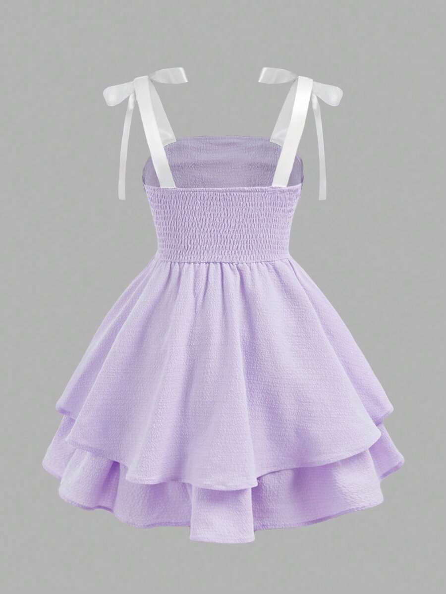 Tween girls apricot tiered cami dress with spaghetti straps, high waist, and slim fit layered hem.