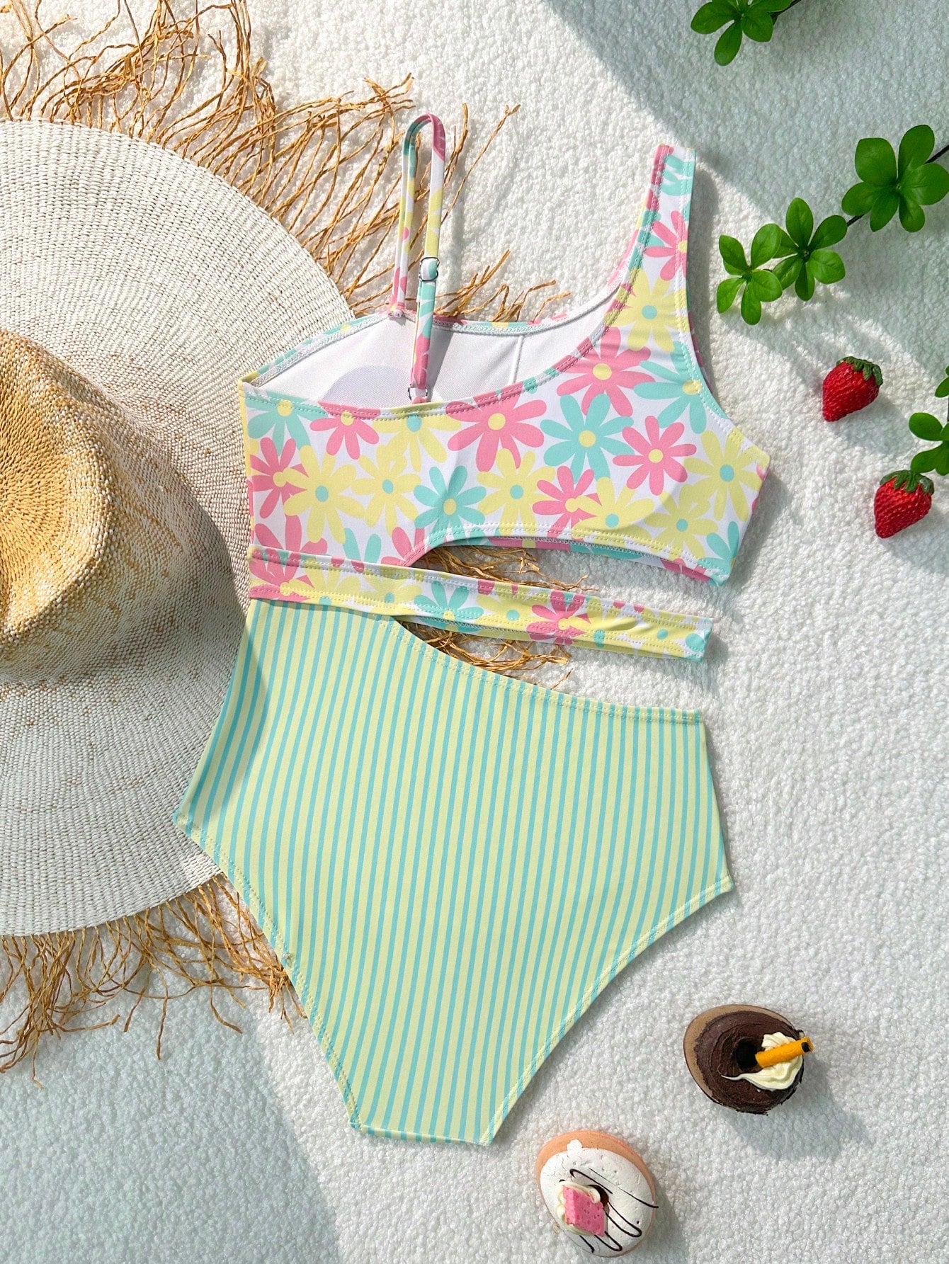 Purple tween girls one-piece swimsuit with asymmetrical neckline, cut-out waist, striped pattern, fitted silhouette, and lined body.