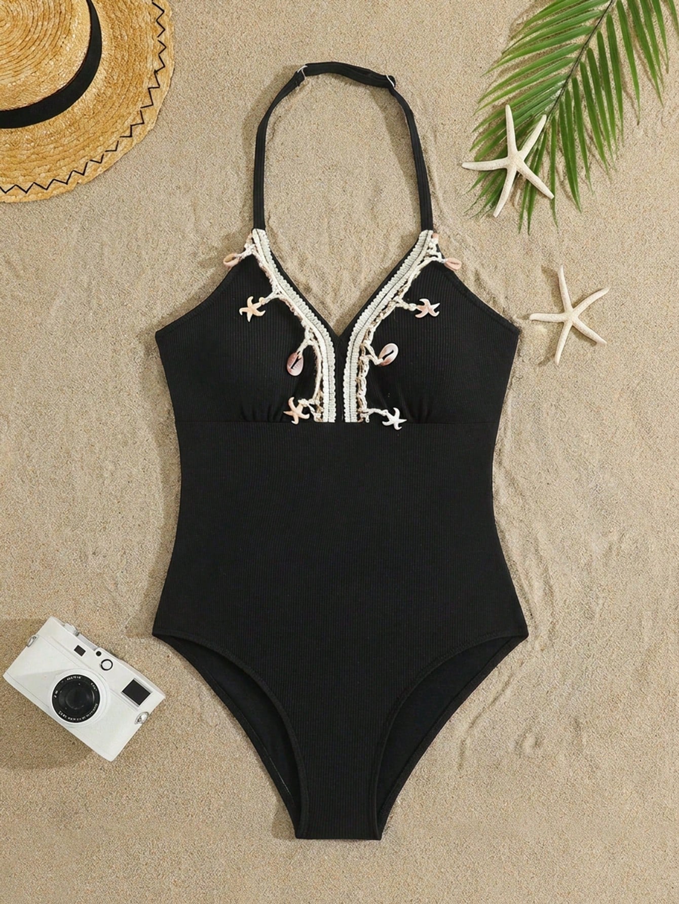 Black tween girls one-piece swimsuit with halter neckline, shell embroidery detail, ribbed texture, and mid-waist bottom for beach, swimming, and vacation wear.