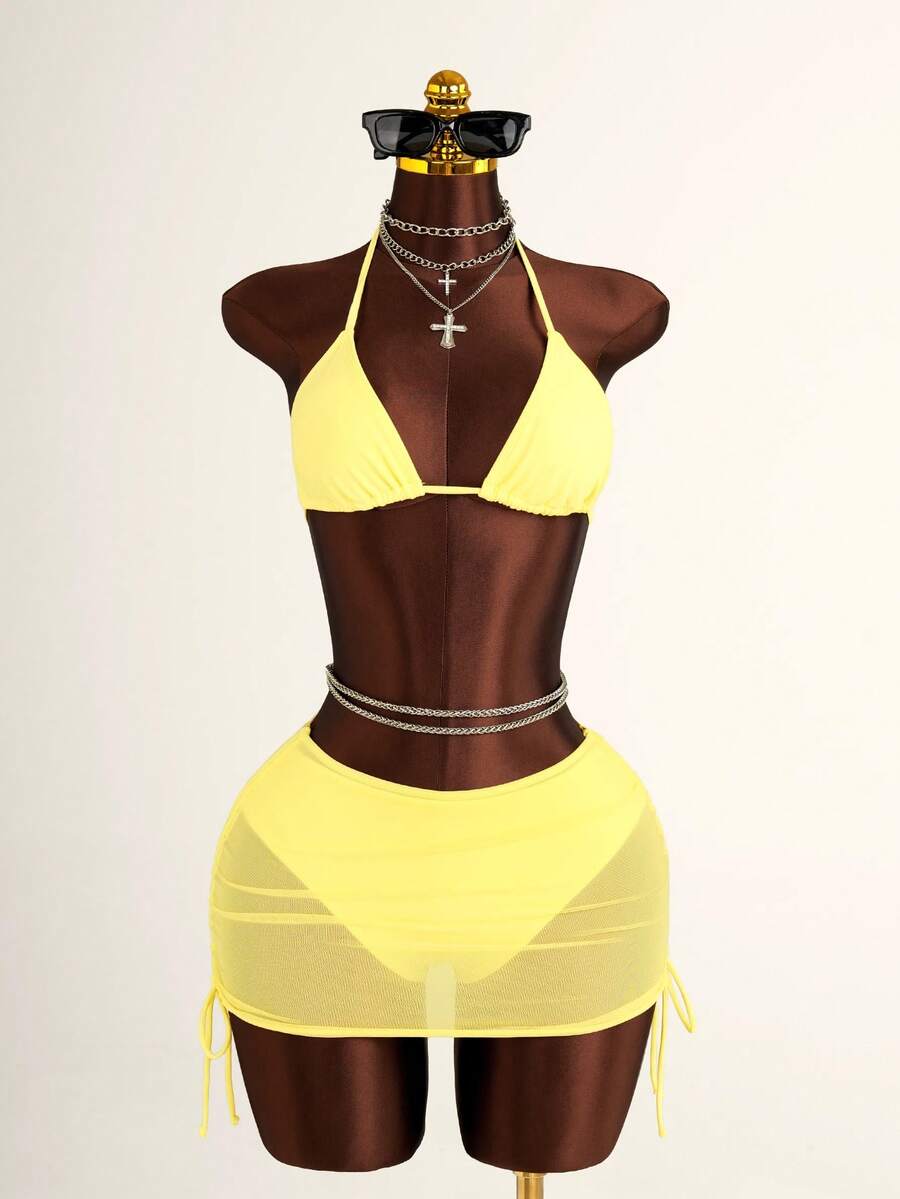 Women's black 3-piece bikini set featuring a halter triangle top with removable padding, high-waisted bottoms, and a knee-length mesh skirt with tie details.