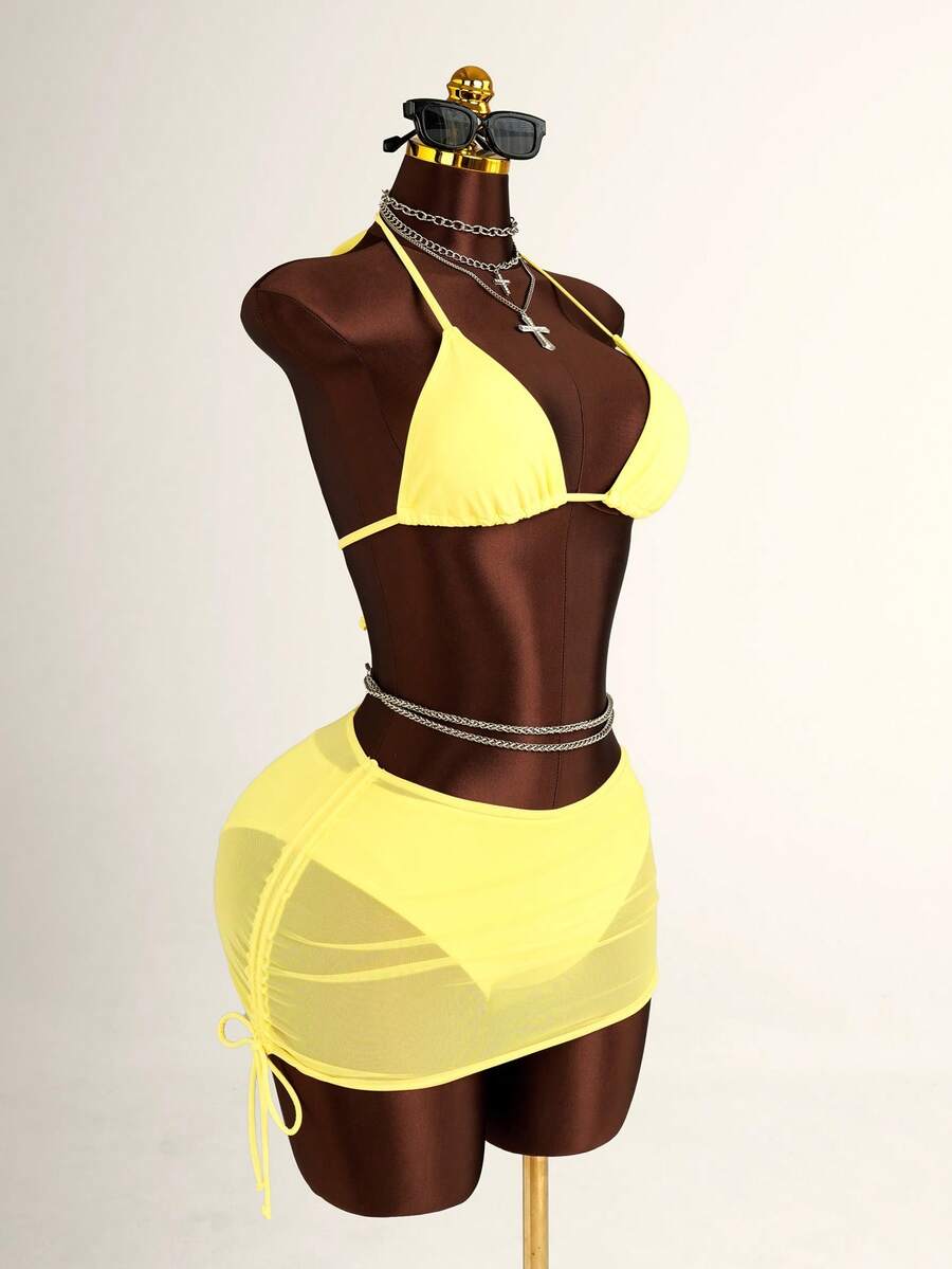 Women's black 3-piece bikini set featuring a halter triangle top with removable padding, high-waisted bottoms, and a knee-length mesh skirt with tie details.