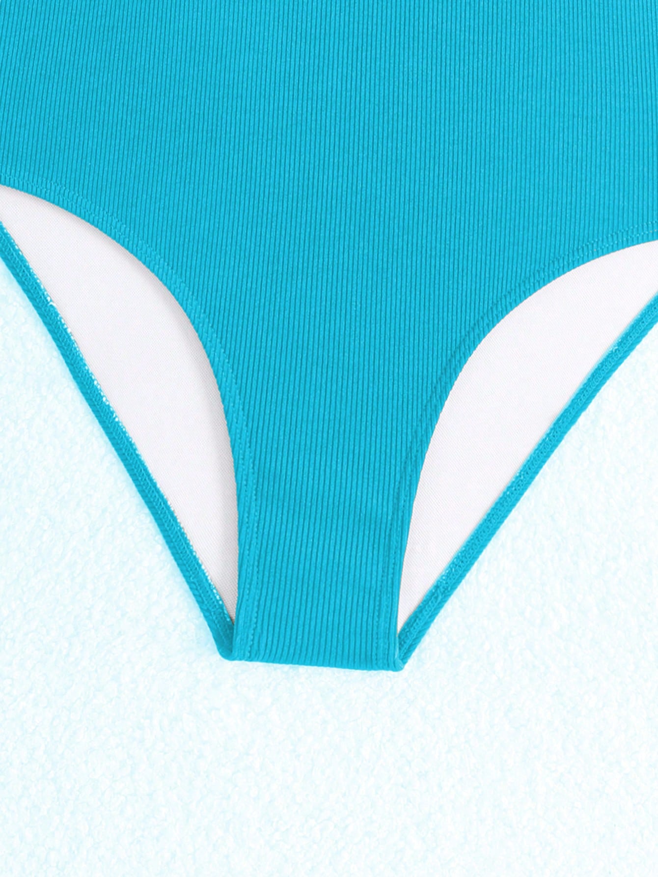 Purple rib knit one-piece swimsuit for tween girls with spaghetti straps, fitted shape, mid-waist bottom, wireless bra, and lined body.