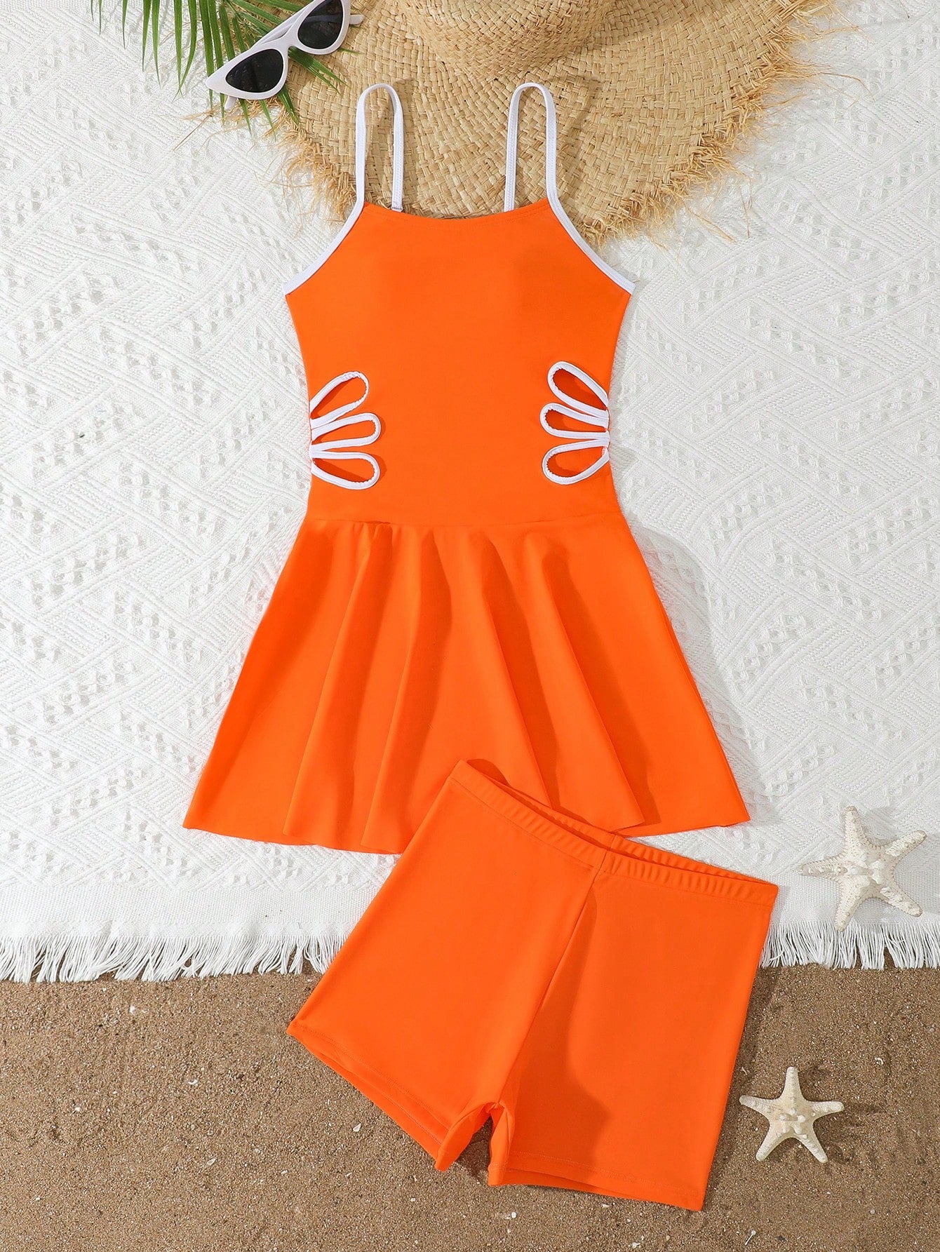 Tween girls black two-piece tankini swimwear set featuring a spaghetti strap sleeveless top with cutout detail and contrast piping, paired with short swim shorts.