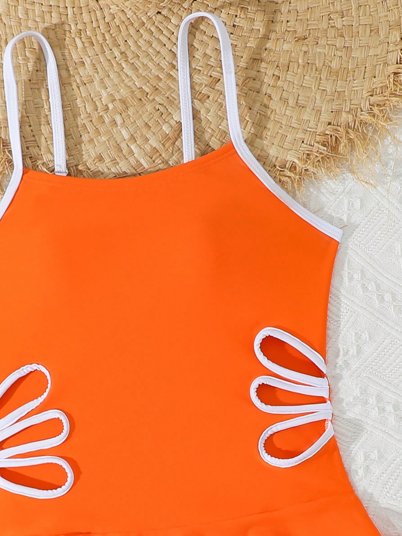 Tween girls black two-piece tankini swimwear set featuring a spaghetti strap sleeveless top with cutout detail and contrast piping, paired with short swim shorts.