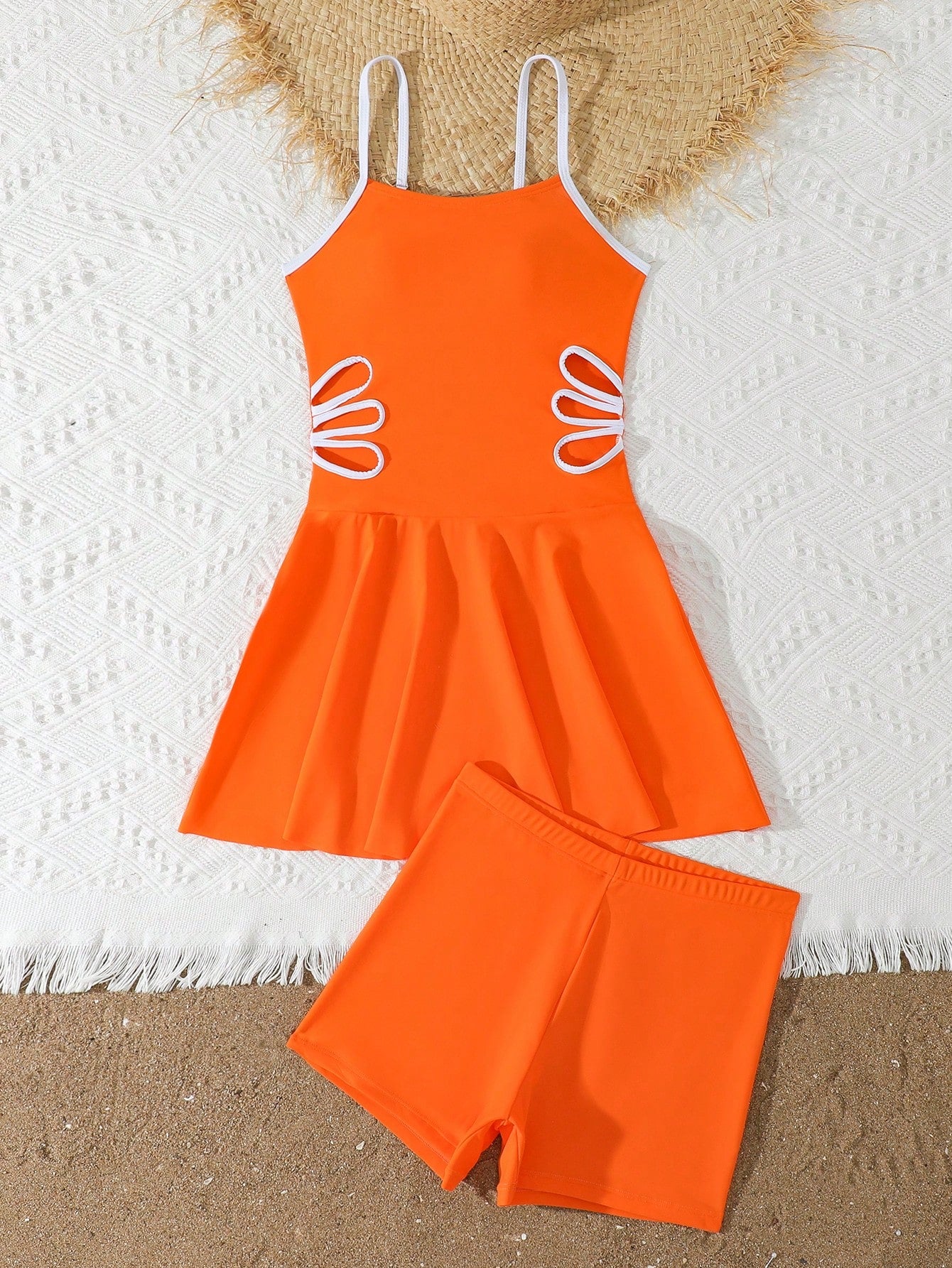 Tween girls black two-piece tankini swimwear set featuring a spaghetti strap sleeveless top with cutout detail and contrast piping, paired with short swim shorts.
