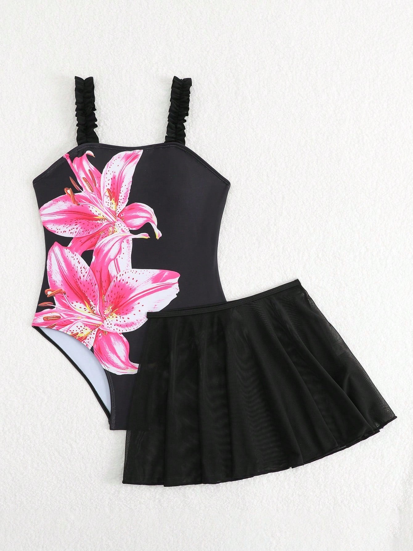Girls floral print swimsuit set with strap neckline, sleeveless fitted top, and pleated mesh skirt bottom for beach and summer vacation wear.