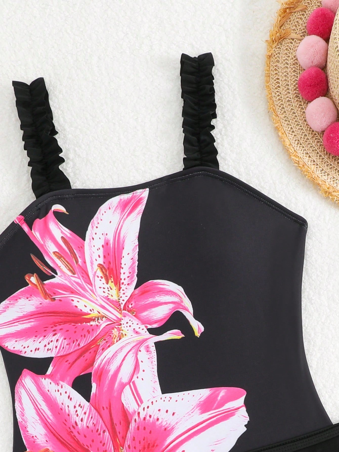 Girls floral print swimsuit set with strap neckline, sleeveless fitted top, and pleated mesh skirt bottom for beach and summer vacation wear.