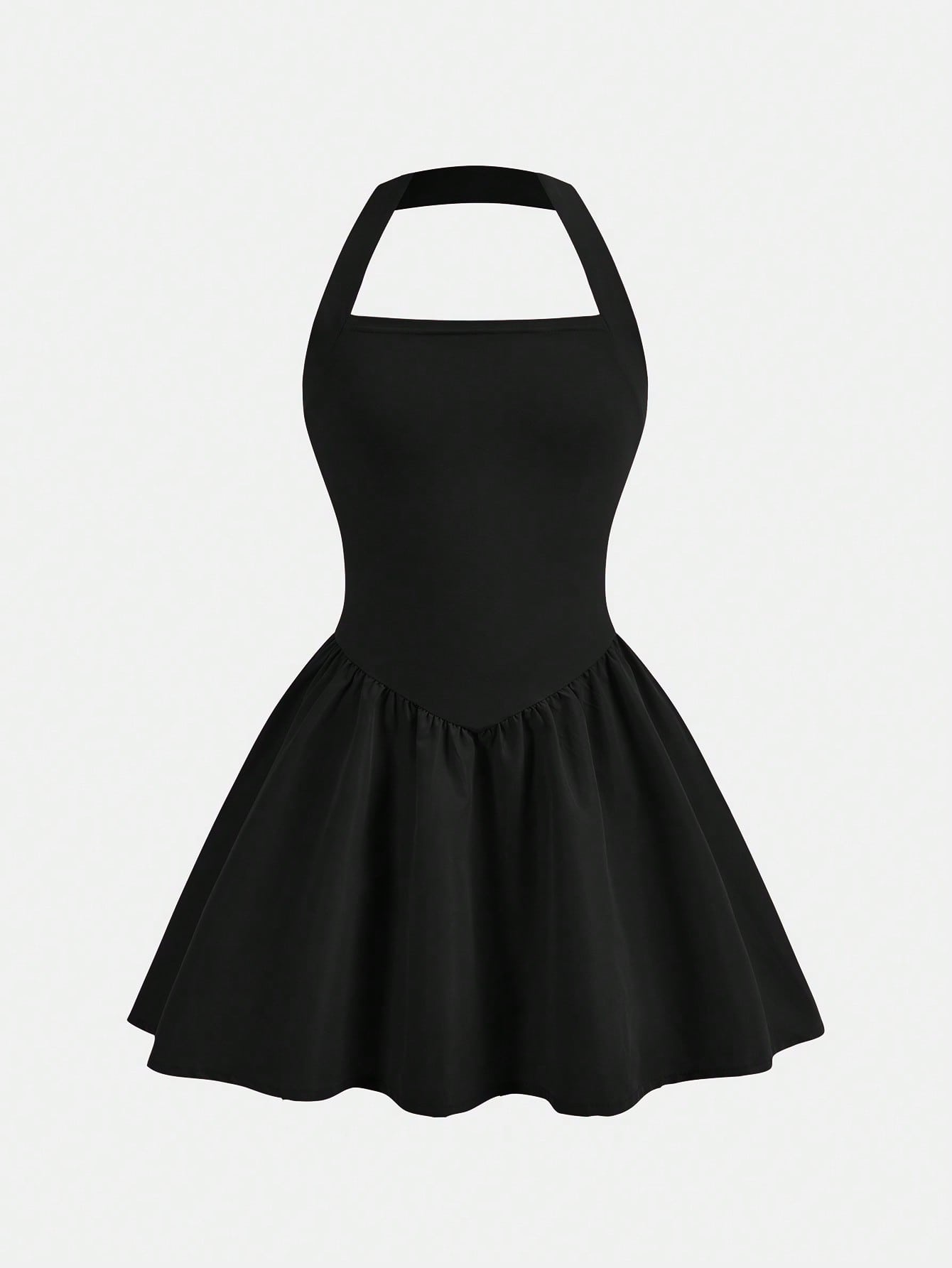 Black sleeveless halter polka dot mini dress for tween girls featuring a high waist and flared hem