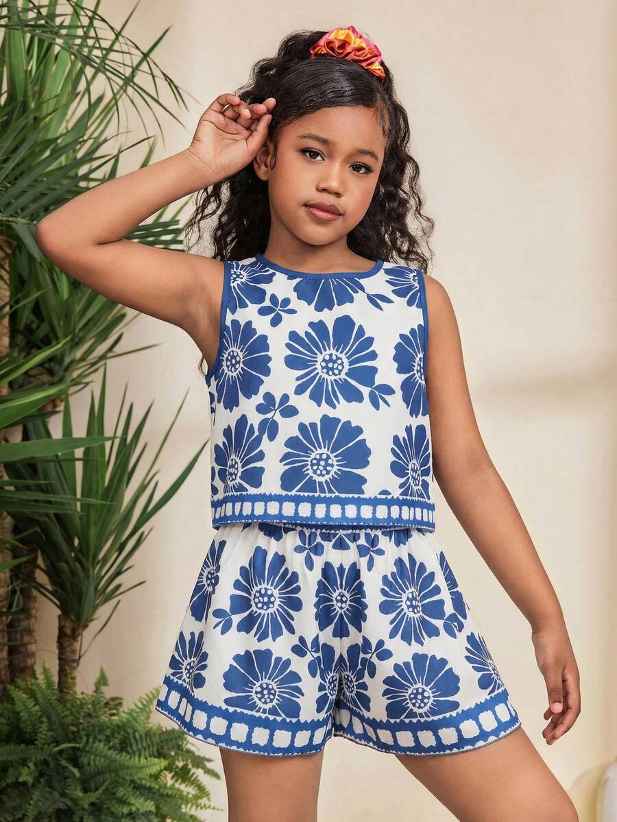Tween girl wearing a tropical floral print two-piece vacation set featuring a sleeveless round neck tank top with button details and matching shorts.