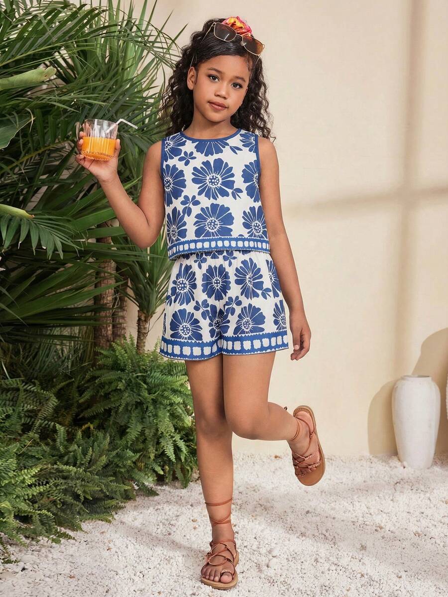 Tween girl wearing a tropical floral print two-piece vacation set featuring a sleeveless round neck tank top with button details and matching shorts.