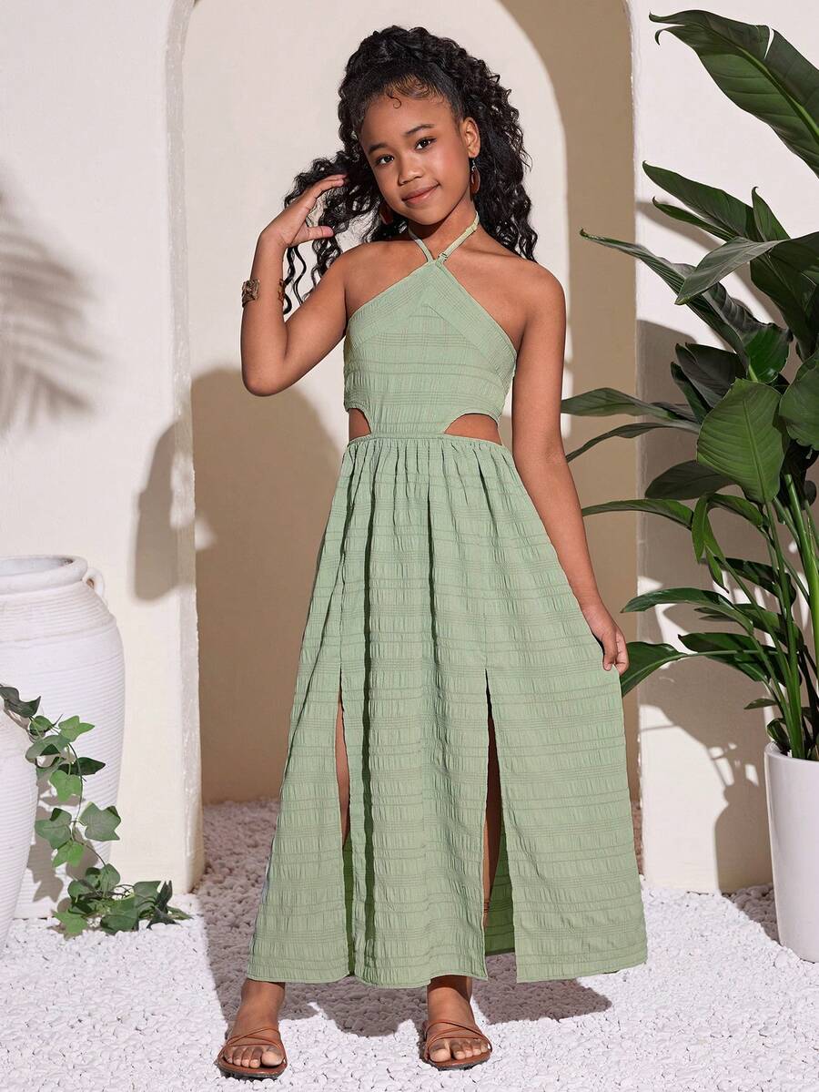 Tween girl yellow long halter dress with cutout waist, split detail, shirred textured fabric, sleeveless design, high waist, and flared hem for beach vacation wear.
