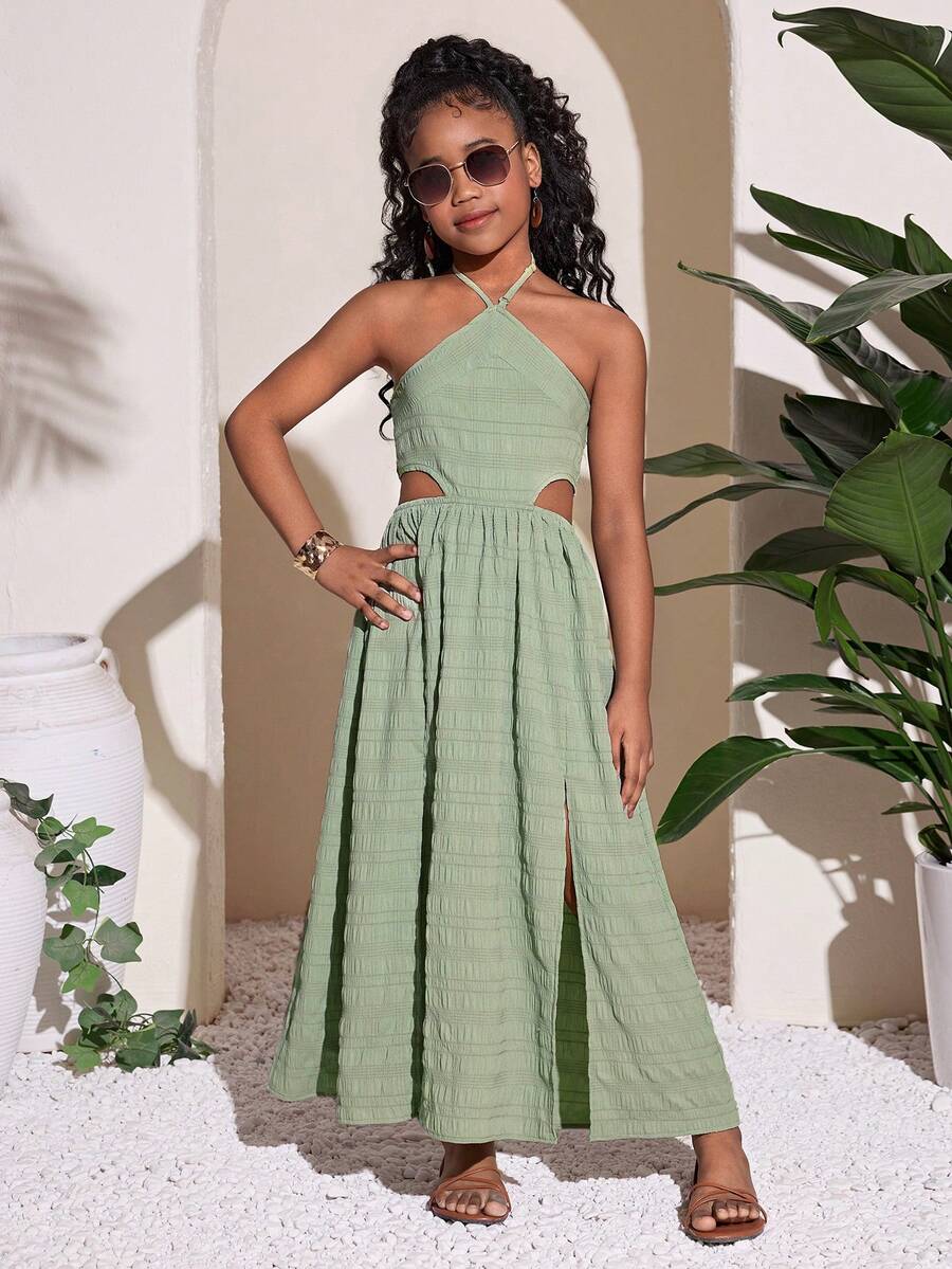 Tween girl yellow long halter dress with cutout waist, split detail, shirred textured fabric, sleeveless design, high waist, and flared hem for beach vacation wear.