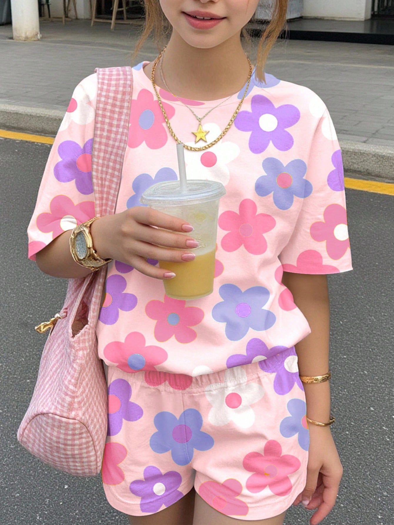 Tween girls multicolor tie-dye 2-piece outfit set featuring a drop-shoulder short-sleeve t-shirt and matching loose track shorts with side pockets.