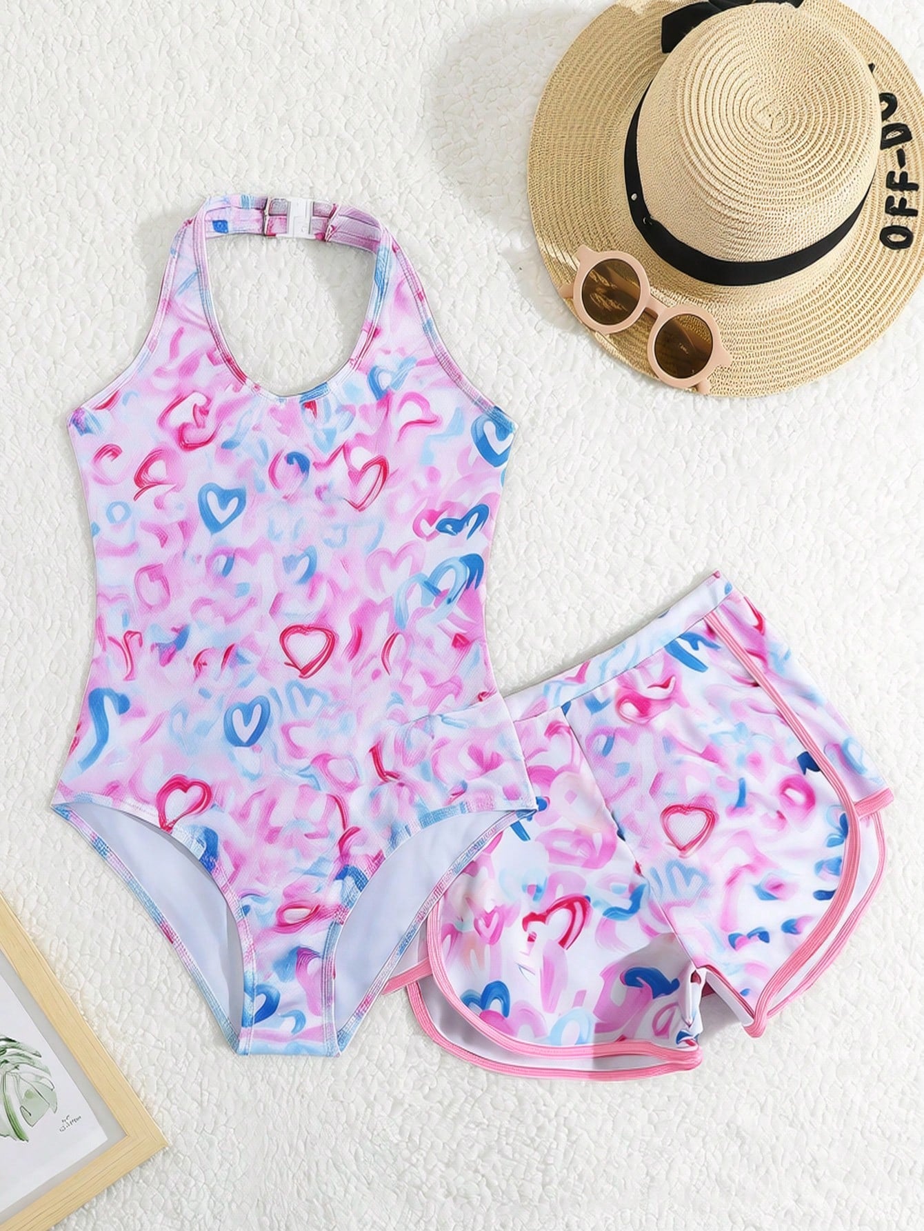 Girls 2-piece swimwear set featuring a butterfly print halter swimsuit top with contrast piping and separate mid-waist shorts; sleeveless, high-stretch, wireless design for beach and vacation wear.
