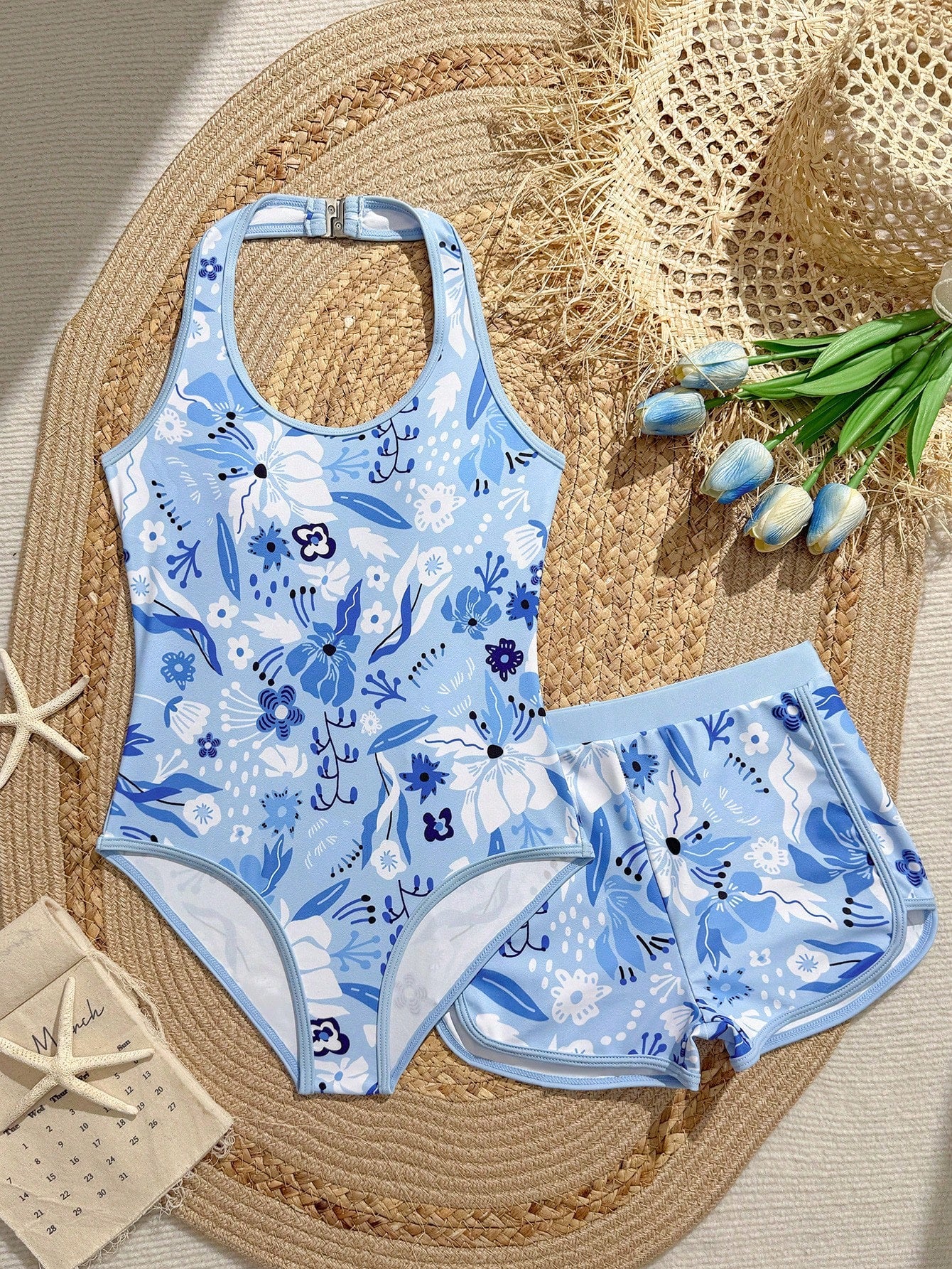 Girls 2-piece swimwear set featuring a butterfly print halter swimsuit top with contrast piping and separate mid-waist shorts; sleeveless, high-stretch, wireless design for beach and vacation wear.