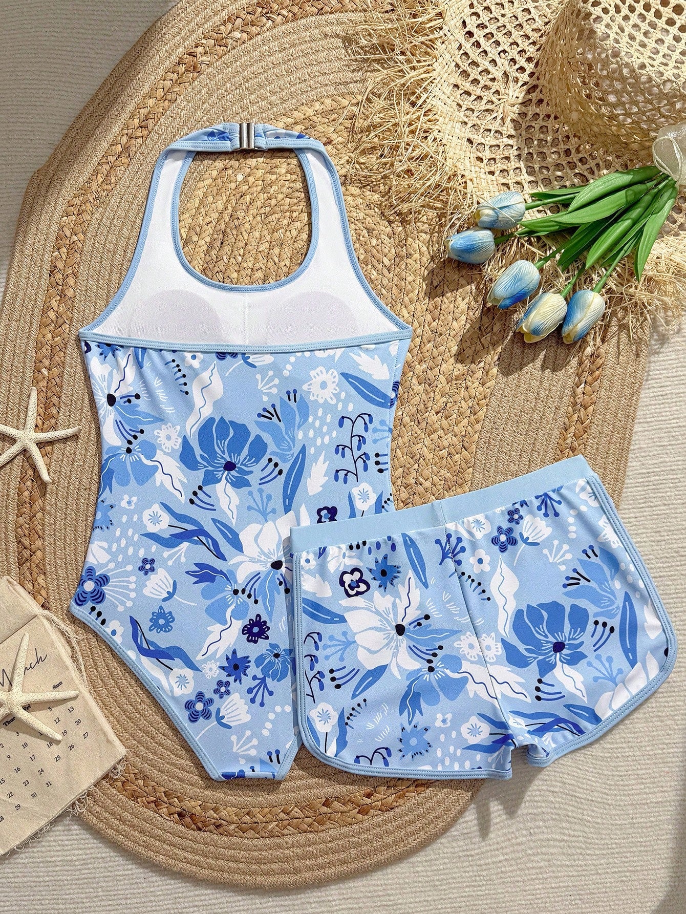 Girls 2-piece swimwear set featuring a butterfly print halter swimsuit top with contrast piping and separate mid-waist shorts; sleeveless, high-stretch, wireless design for beach and vacation wear.