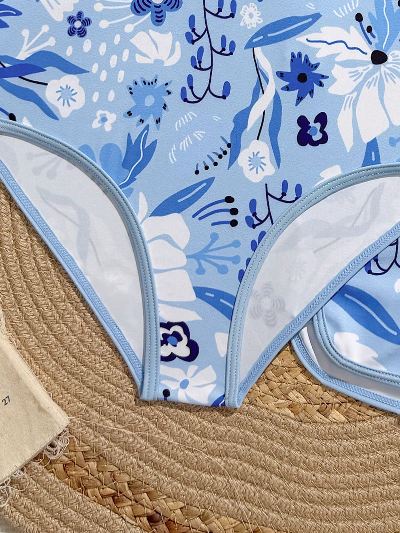 Girls 2-piece swimwear set featuring a butterfly print halter swimsuit top with contrast piping and separate mid-waist shorts; sleeveless, high-stretch, wireless design for beach and vacation wear.