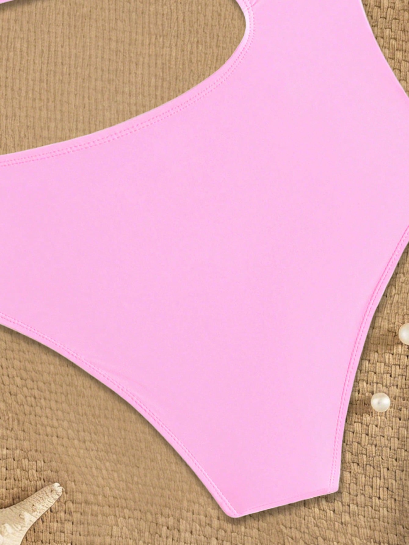 Pink colorblock one-piece swimsuit for tween girls with spaghetti straps, cut-out detail, lined body, and mid-waist bottom for swimming, beach, and vacation wear.