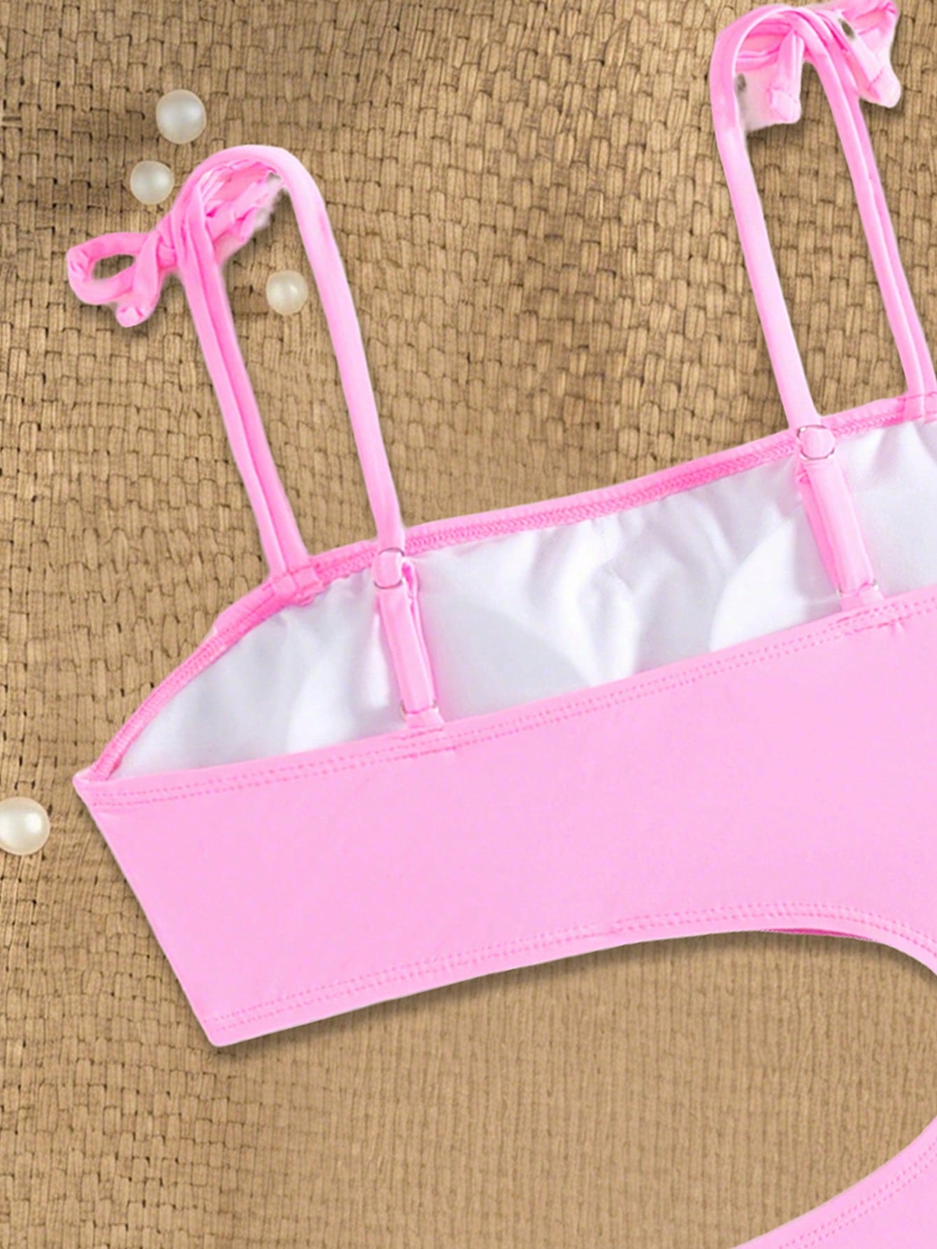 Pink colorblock one-piece swimsuit for tween girls with spaghetti straps, cut-out detail, lined body, and mid-waist bottom for swimming, beach, and vacation wear.