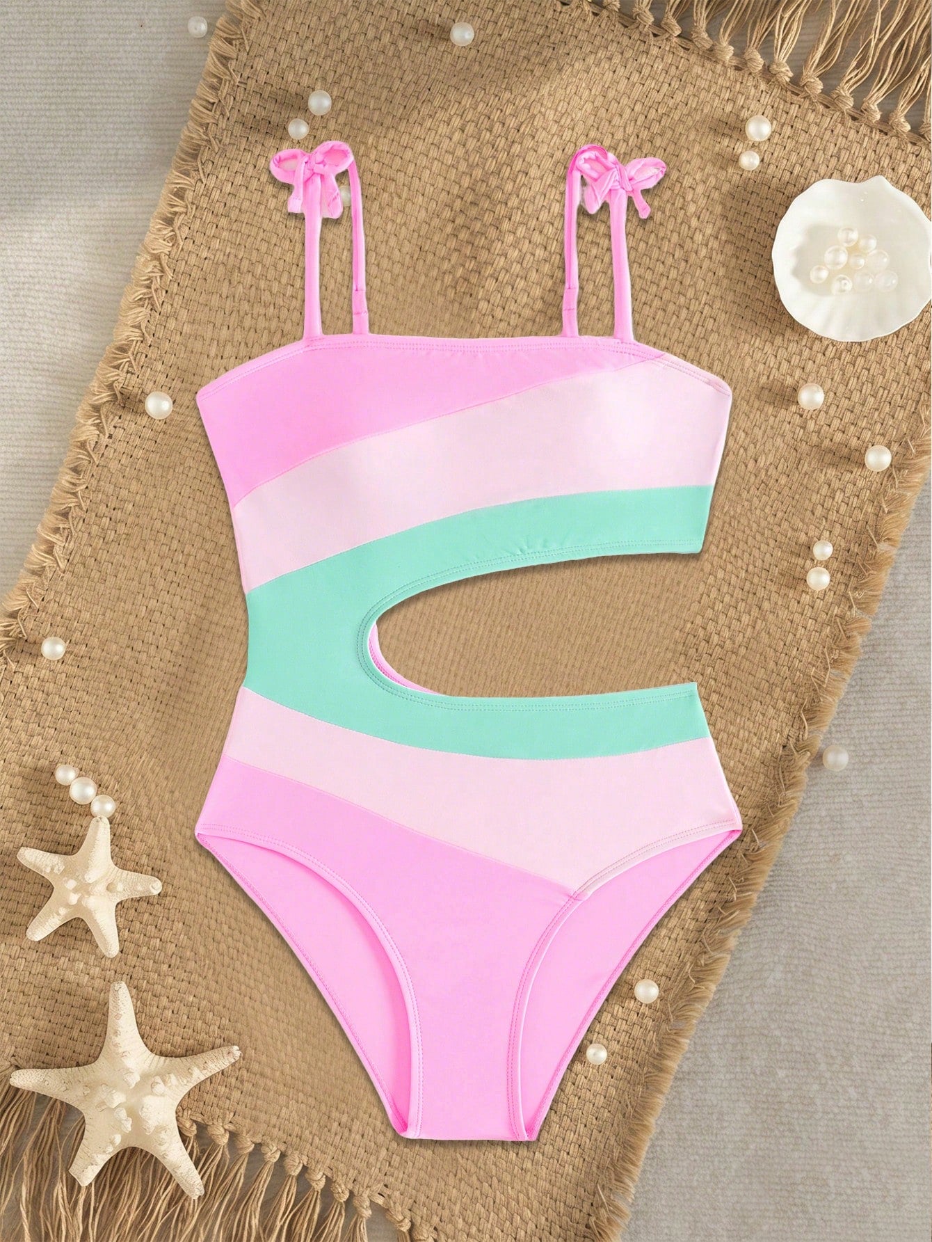 Pink colorblock one-piece swimsuit for tween girls with spaghetti straps, cut-out detail, lined body, and mid-waist bottom for swimming, beach, and vacation wear.