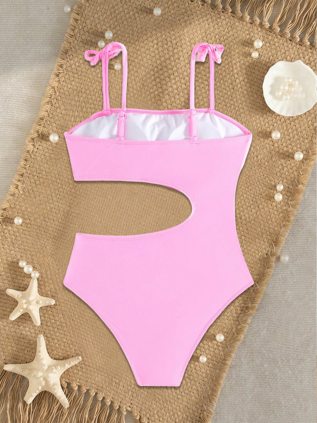 Pink colorblock one-piece swimsuit for tween girls with spaghetti straps, cut-out detail, lined body, and mid-waist bottom for swimming, beach, and vacation wear.