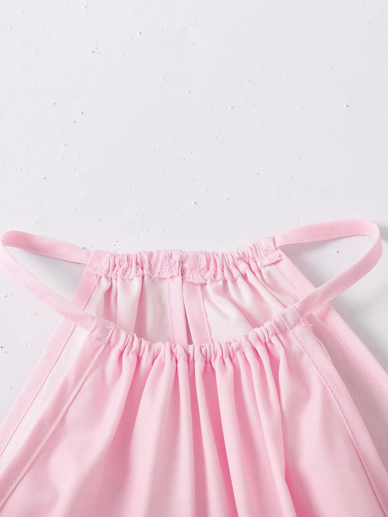 Tween girls floral print dress with halter neckline, sleeveless cold shoulder design, A-line shape, and vacation style.