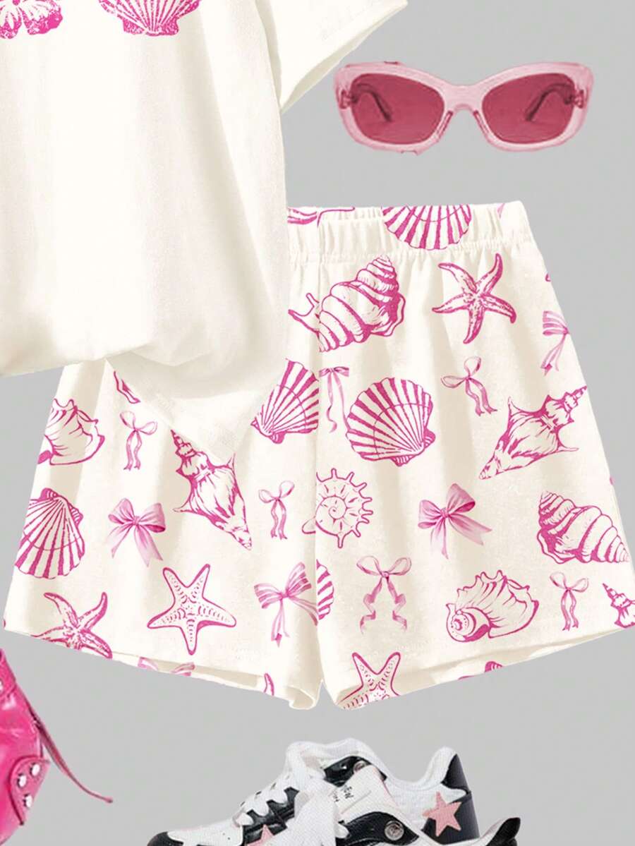 Tween girls 2-piece summer casual outfit featuring a multicolor seashell print short sleeve T-shirt with drop shoulders and matching loose fit shorts with pockets.