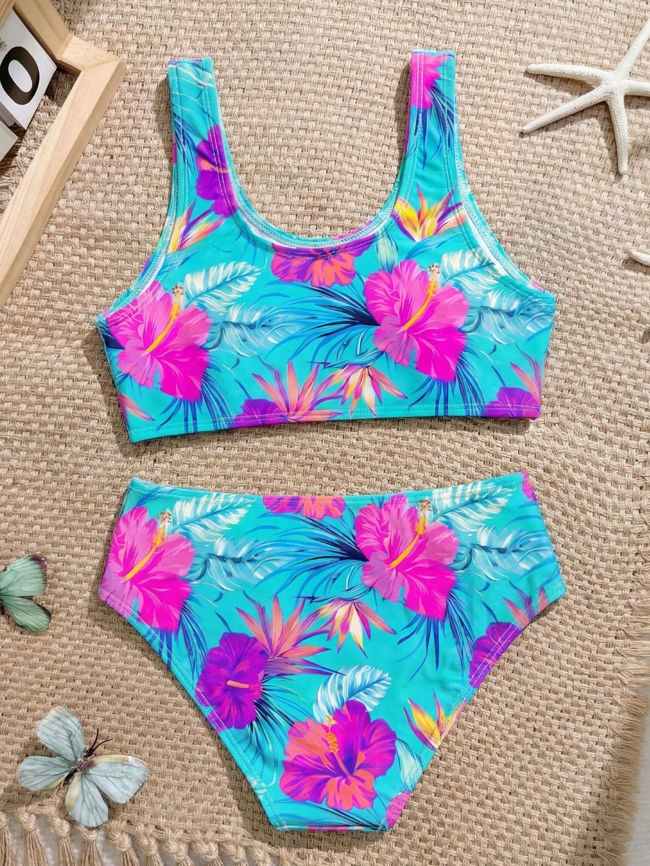 Tween girls 2-piece ditsy floral bikini set featuring a spaghetti strap top with center string detail and matching bottoms with side strings, designed for swimming, vacation, and summer wear.