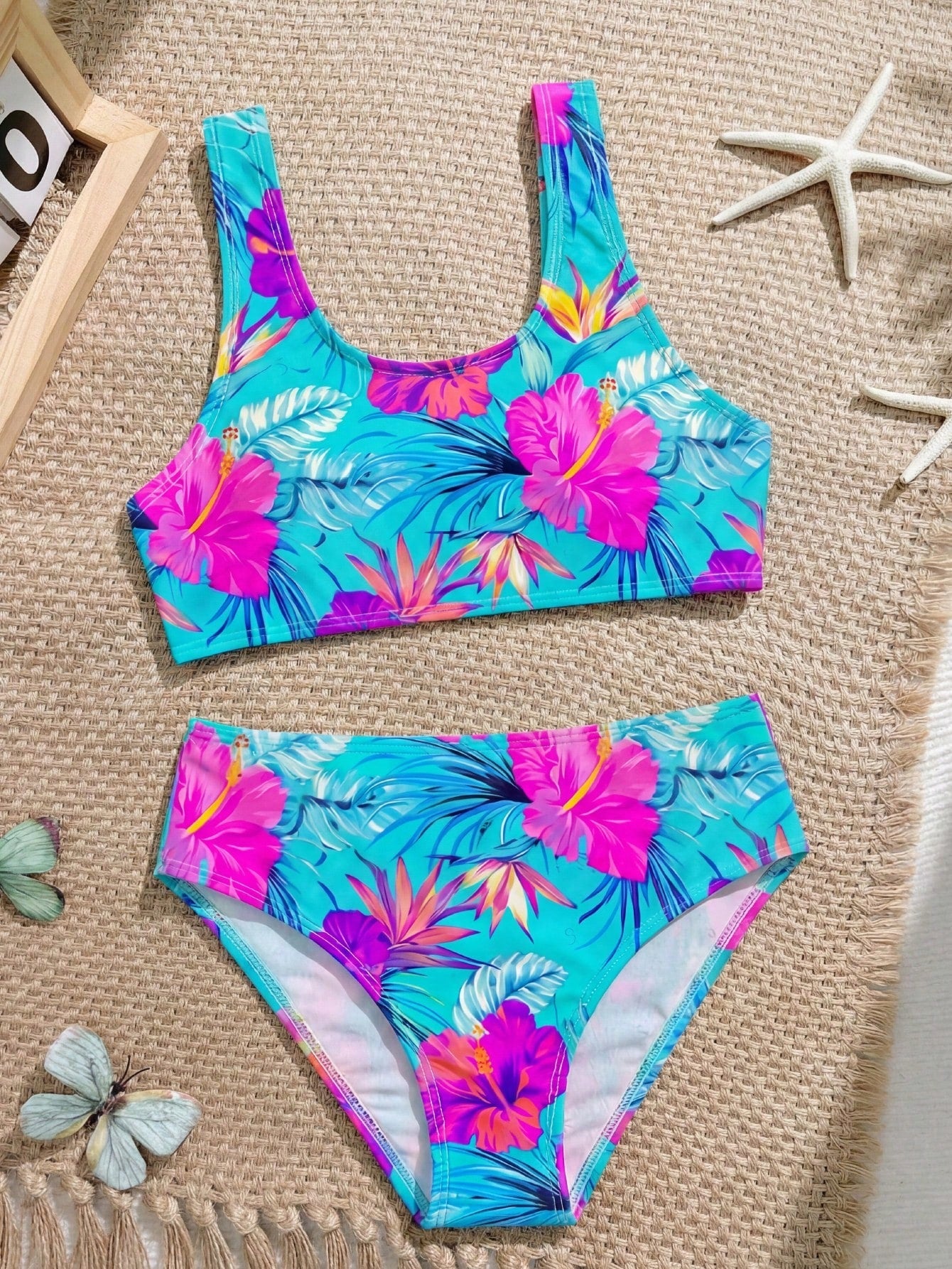 Tween girls 2-piece ditsy floral bikini set featuring a spaghetti strap top with center string detail and matching bottoms with side strings, designed for swimming, vacation, and summer wear.