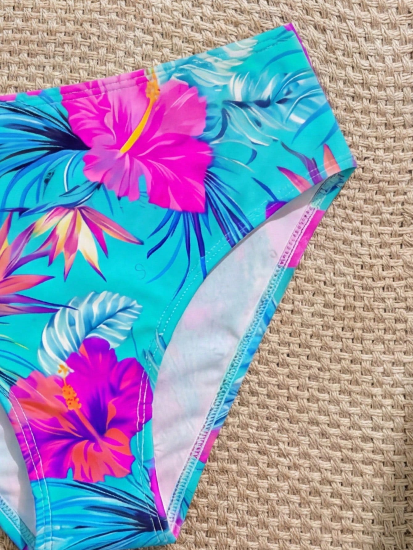 Tween girls 2-piece ditsy floral bikini set featuring a spaghetti strap top with center string detail and matching bottoms with side strings, designed for swimming, vacation, and summer wear.
