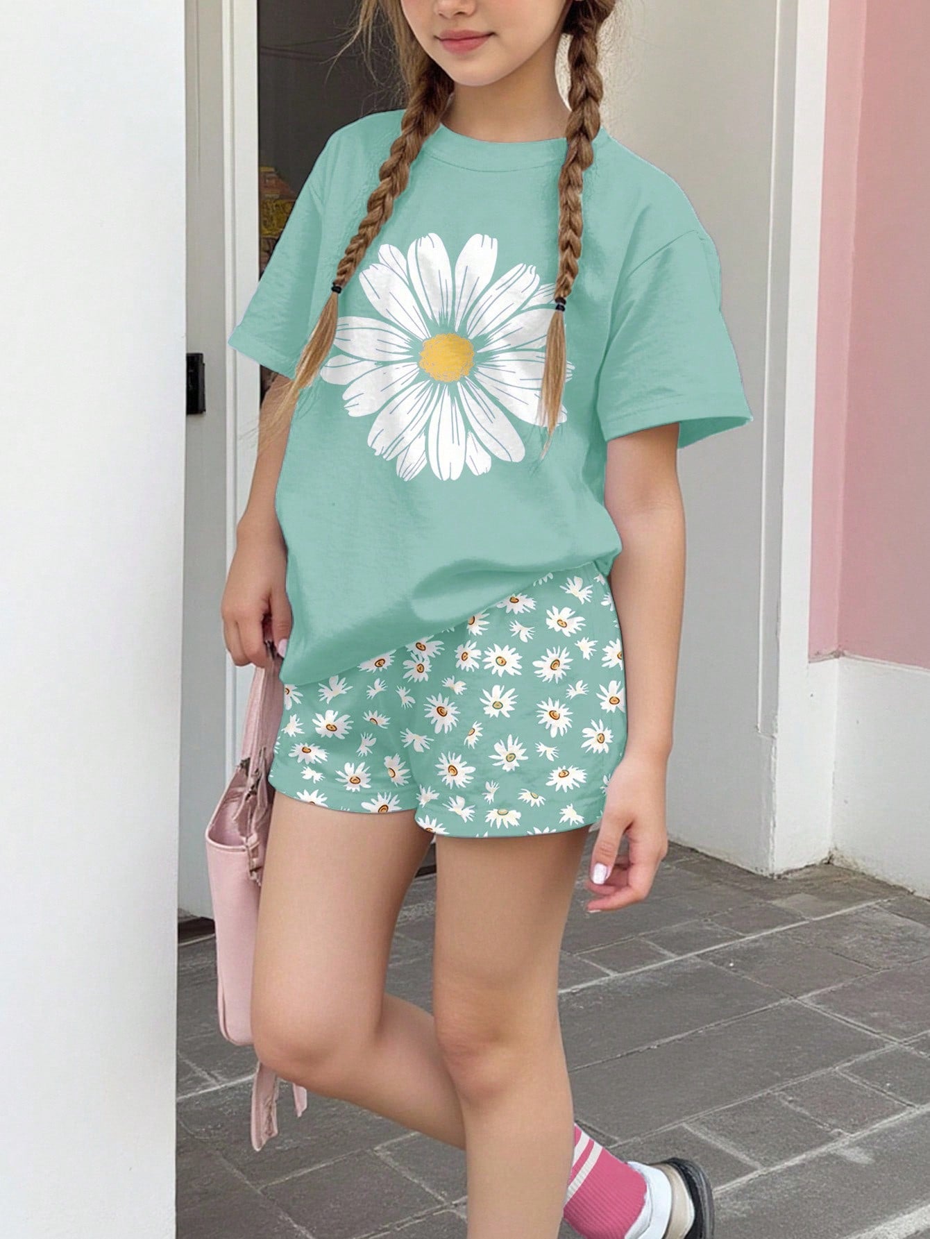 Tween girls 2-piece summer casual outfit featuring a multicolor seashell print short sleeve T-shirt with drop shoulders and matching loose fit shorts with pockets.