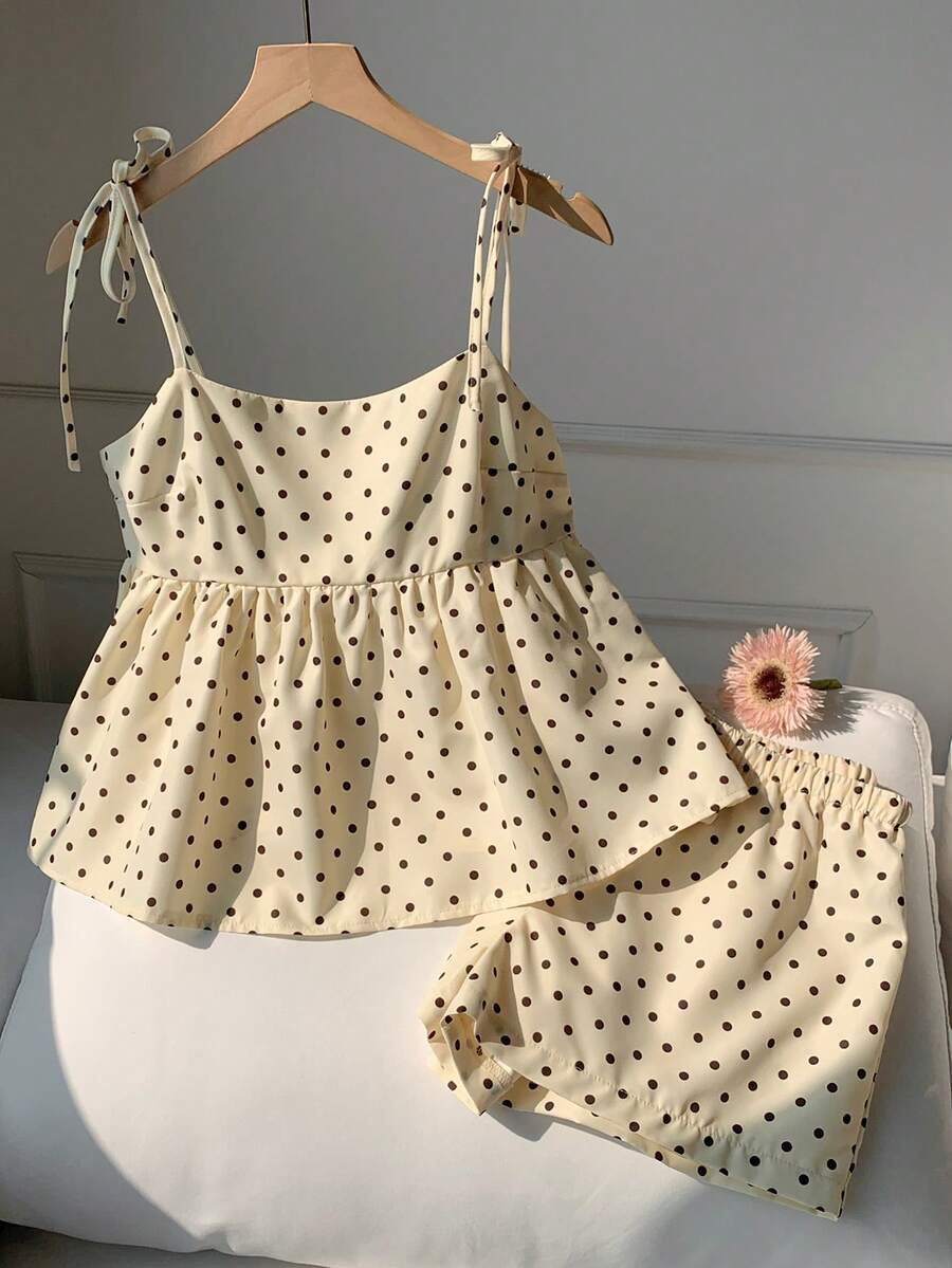 Tween girl 2-piece summer set with a black and white sleeveless striped spaghetti strap tank top with ruffle details and matching casual shorts.