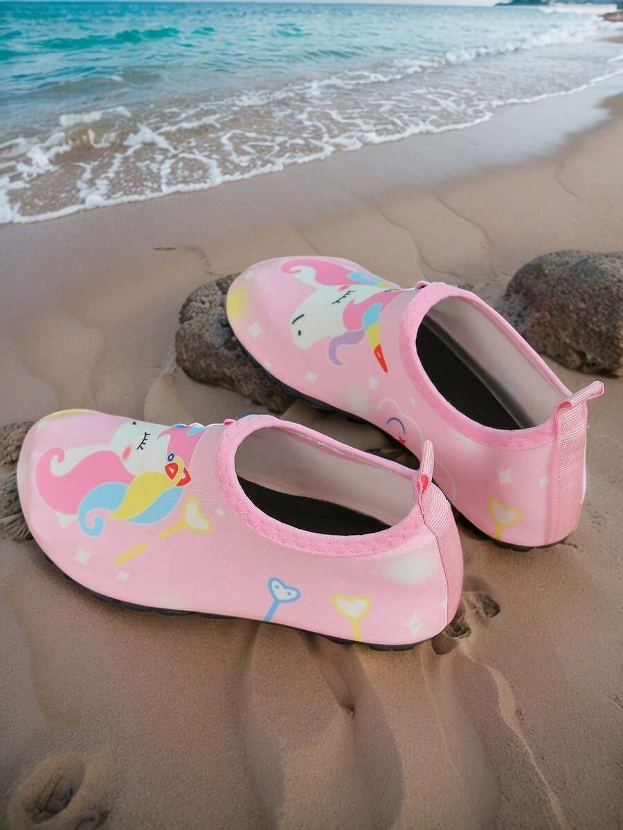 Pink slip-on elastic water shoes for girls featuring a cartoon pattern and non-slip TPR outsole.