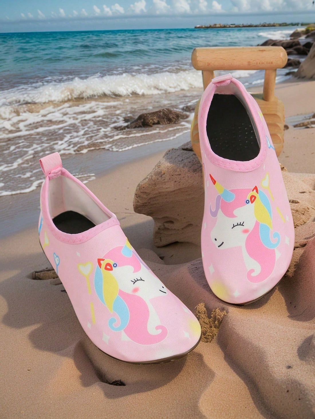 Pink slip-on elastic water shoes for girls featuring a cartoon pattern and non-slip TPR outsole.