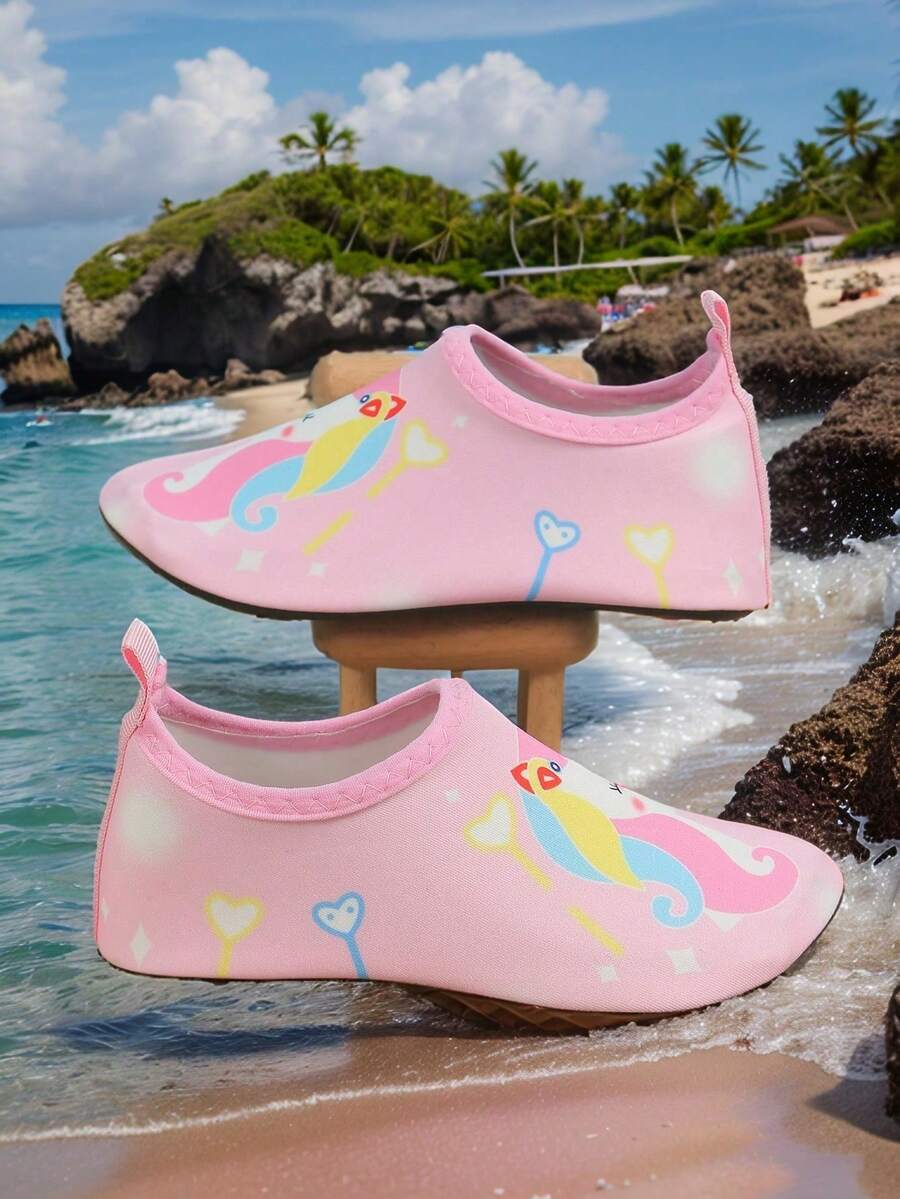 Pink slip-on elastic water shoes for girls featuring a cartoon pattern and non-slip TPR outsole.