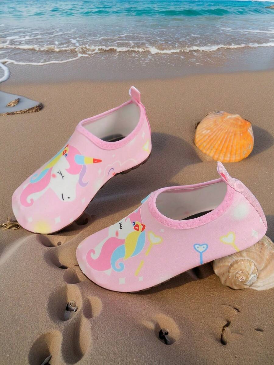 Pink slip-on elastic water shoes for girls featuring a cartoon pattern and non-slip TPR outsole.