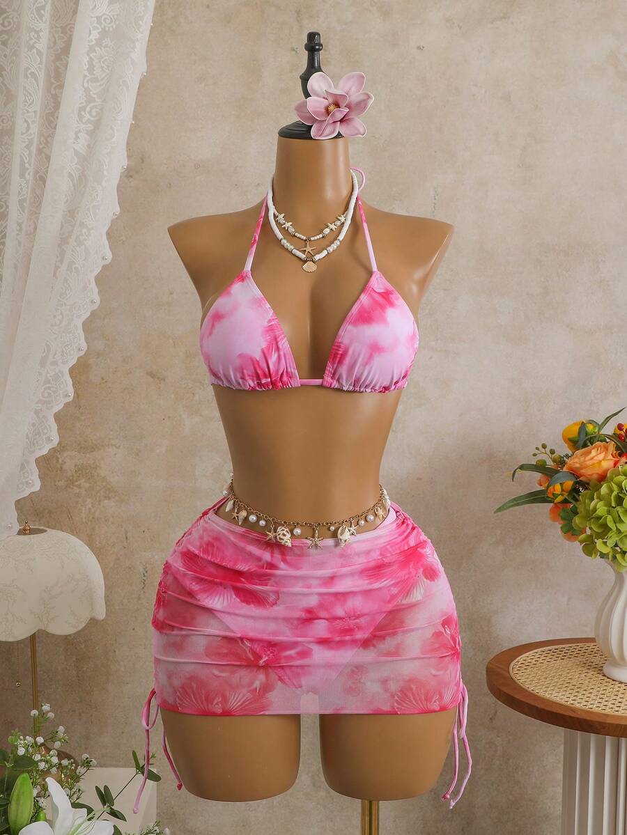 Women's black 3-piece bikini set featuring a halter triangle top with removable padding, high-waisted bottoms, and a knee-length mesh skirt with tie details.