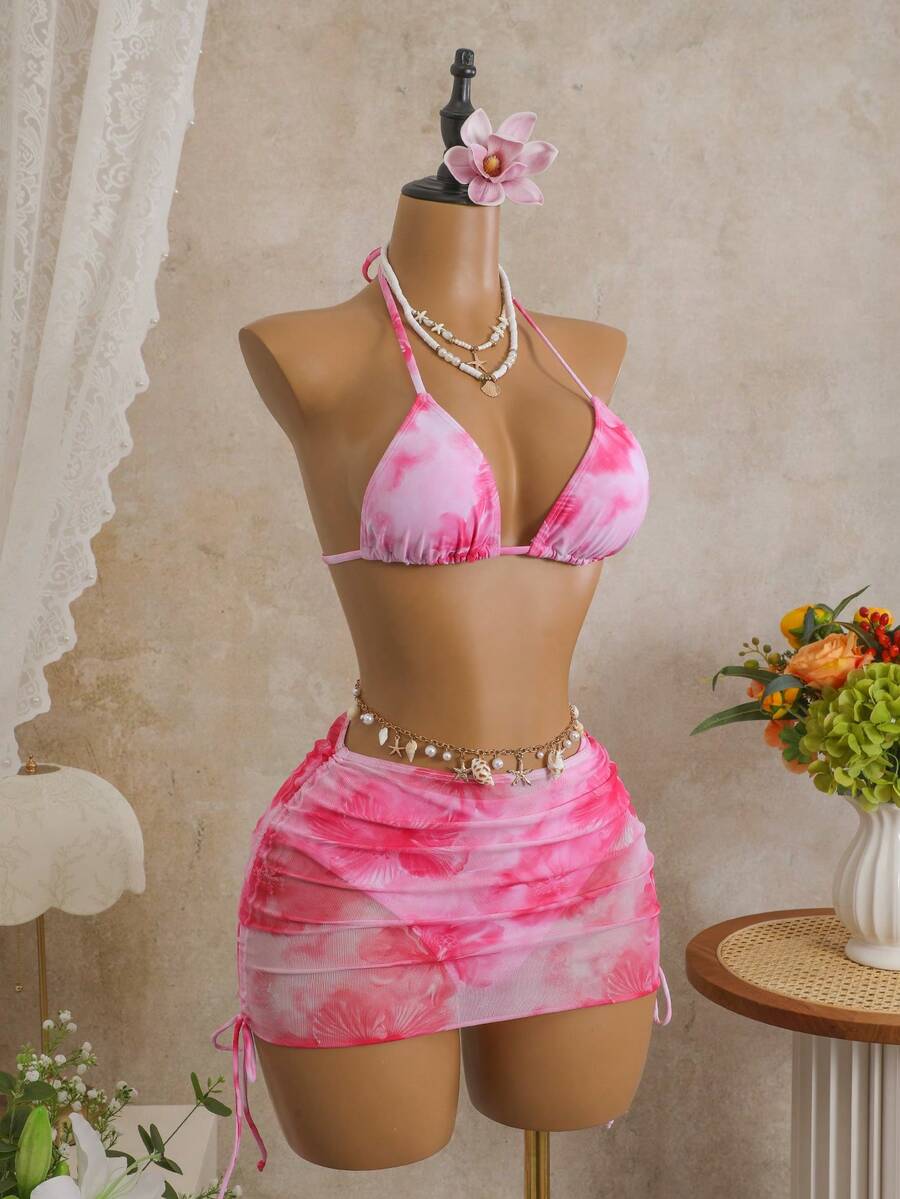 Women's black 3-piece bikini set featuring a halter triangle top with removable padding, high-waisted bottoms, and a knee-length mesh skirt with tie details.
