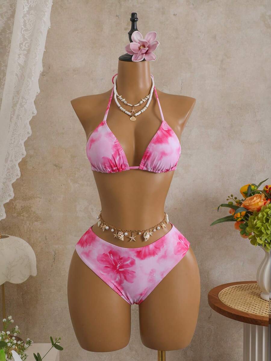 Women's black 3-piece bikini set featuring a halter triangle top with removable padding, high-waisted bottoms, and a knee-length mesh skirt with tie details.