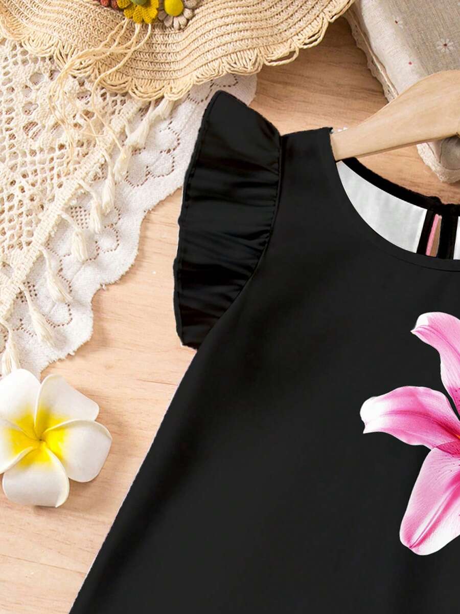 Tween girls sleeveless tropical floral mini dress in black with round neck and ruffle hem detail