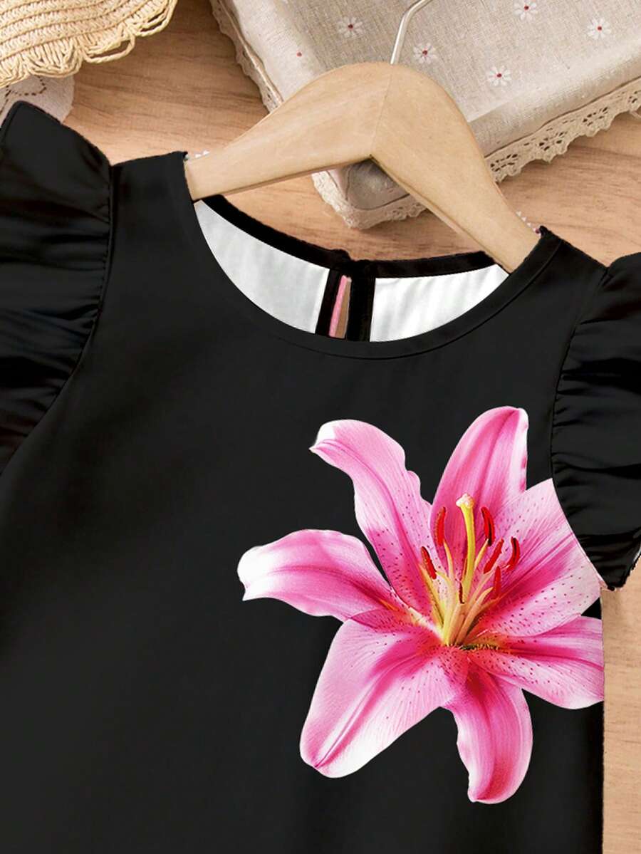 Tween girls sleeveless tropical floral mini dress in black with round neck and ruffle hem detail