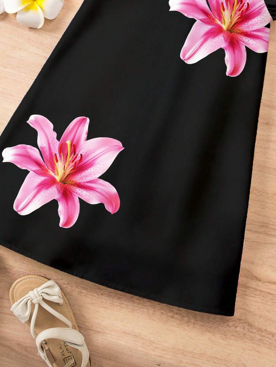 Tween girls sleeveless tropical floral mini dress in black with round neck and ruffle hem detail