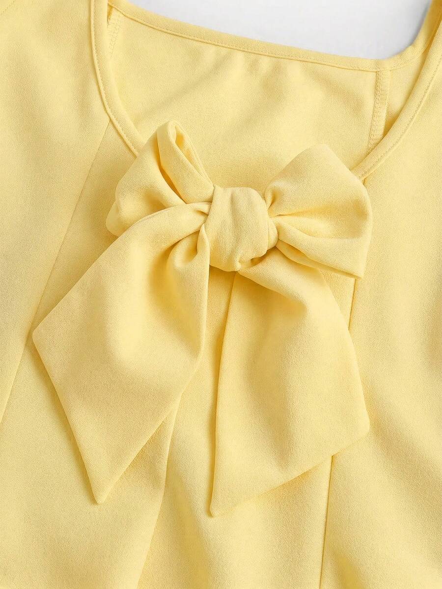 Apricot short-sleeve holiday party dress for tween girls featuring a square neckline, contrast lace details, high waist, flared A-line hem, and bowknot ruffle back detail.