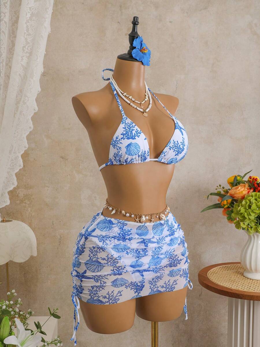 Women's black 3-piece bikini set featuring a halter triangle top with removable padding, high-waisted bottoms, and a knee-length mesh skirt with tie details.