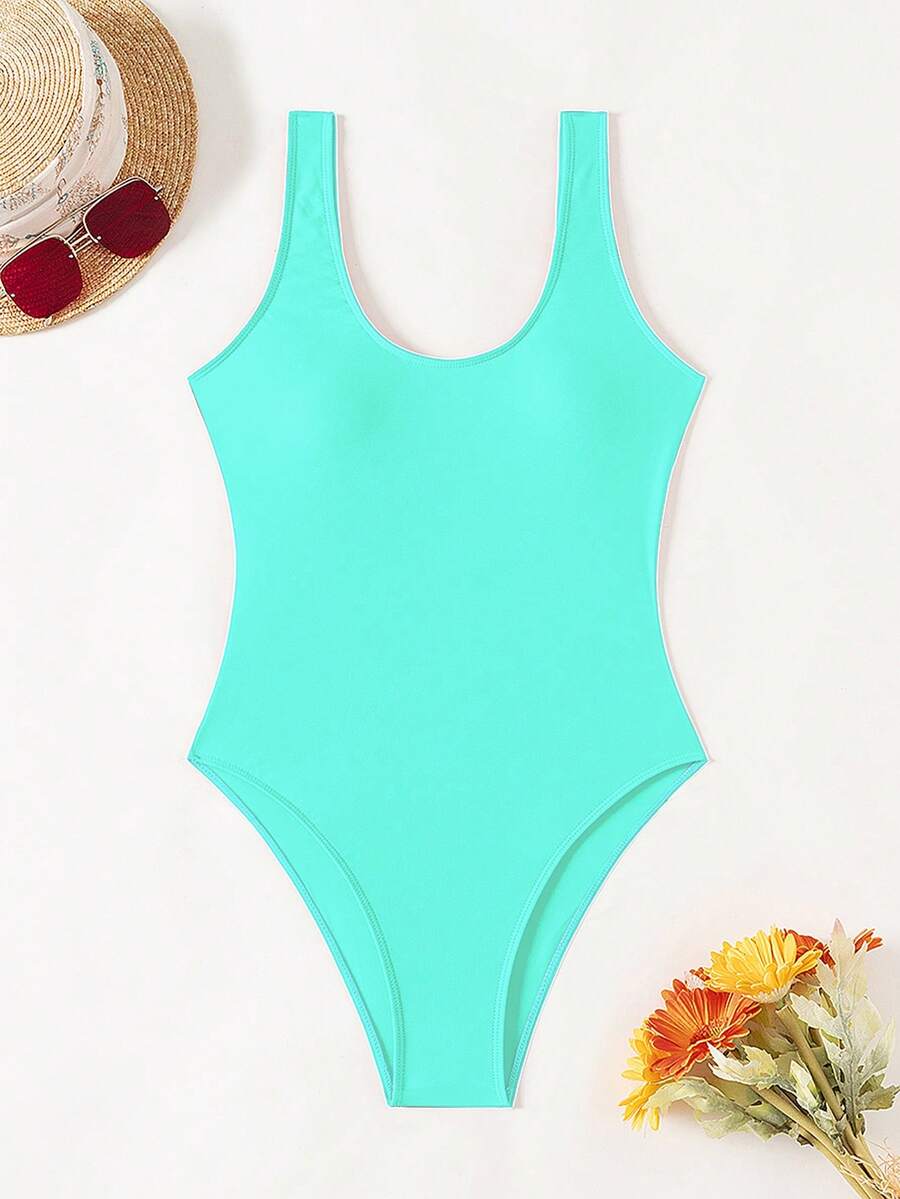 Women's solid color one-piece swimsuit featuring a backless scoop neck design and high cut fit