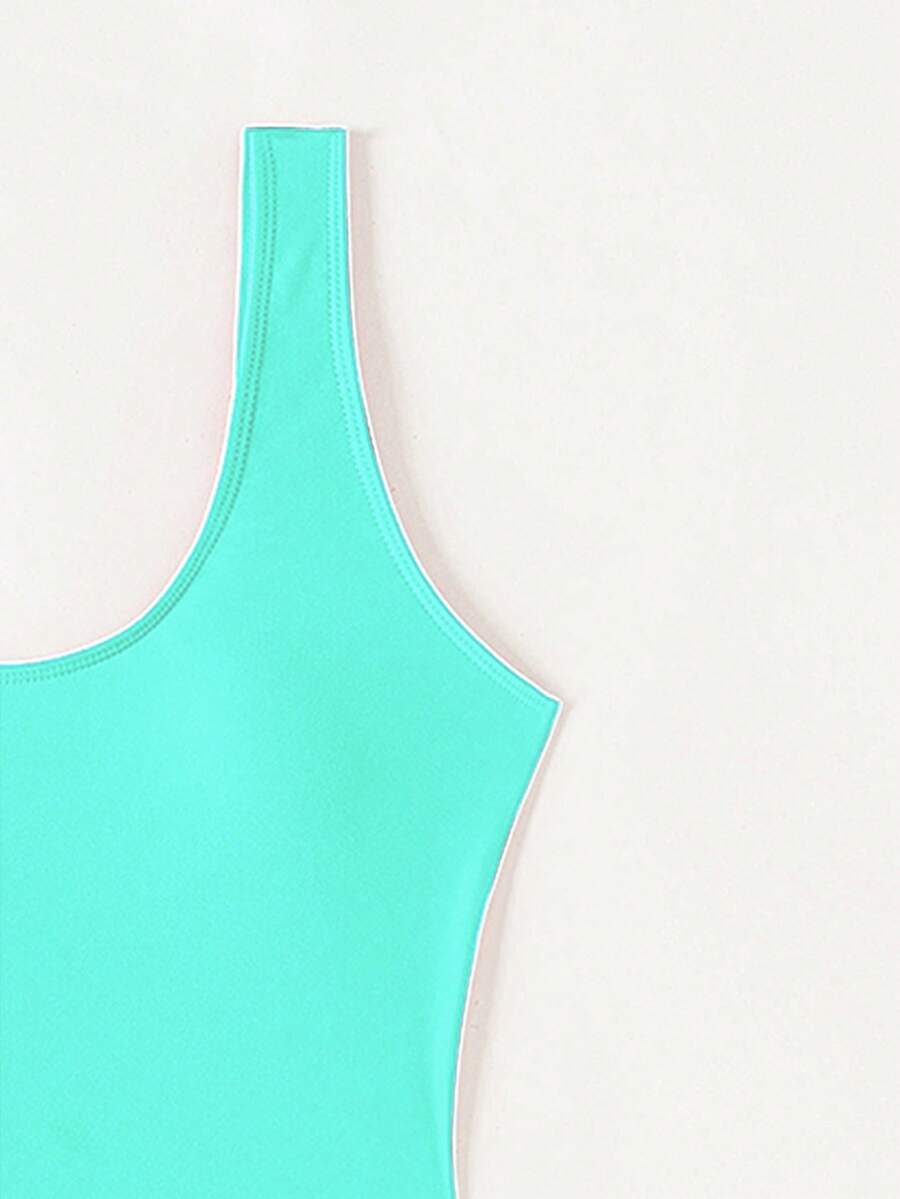 Women's solid color one-piece swimsuit featuring a backless scoop neck design and high cut fit