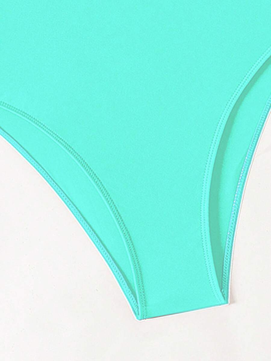 Women's solid color one-piece swimsuit featuring a backless scoop neck design and high cut fit