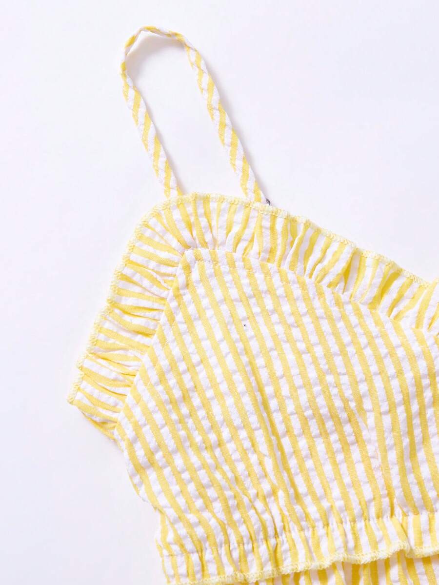 Tween girls 2-piece set featuring a short V-neck ruffle camisole top and matching long pants made of bubble crinkle fabric.